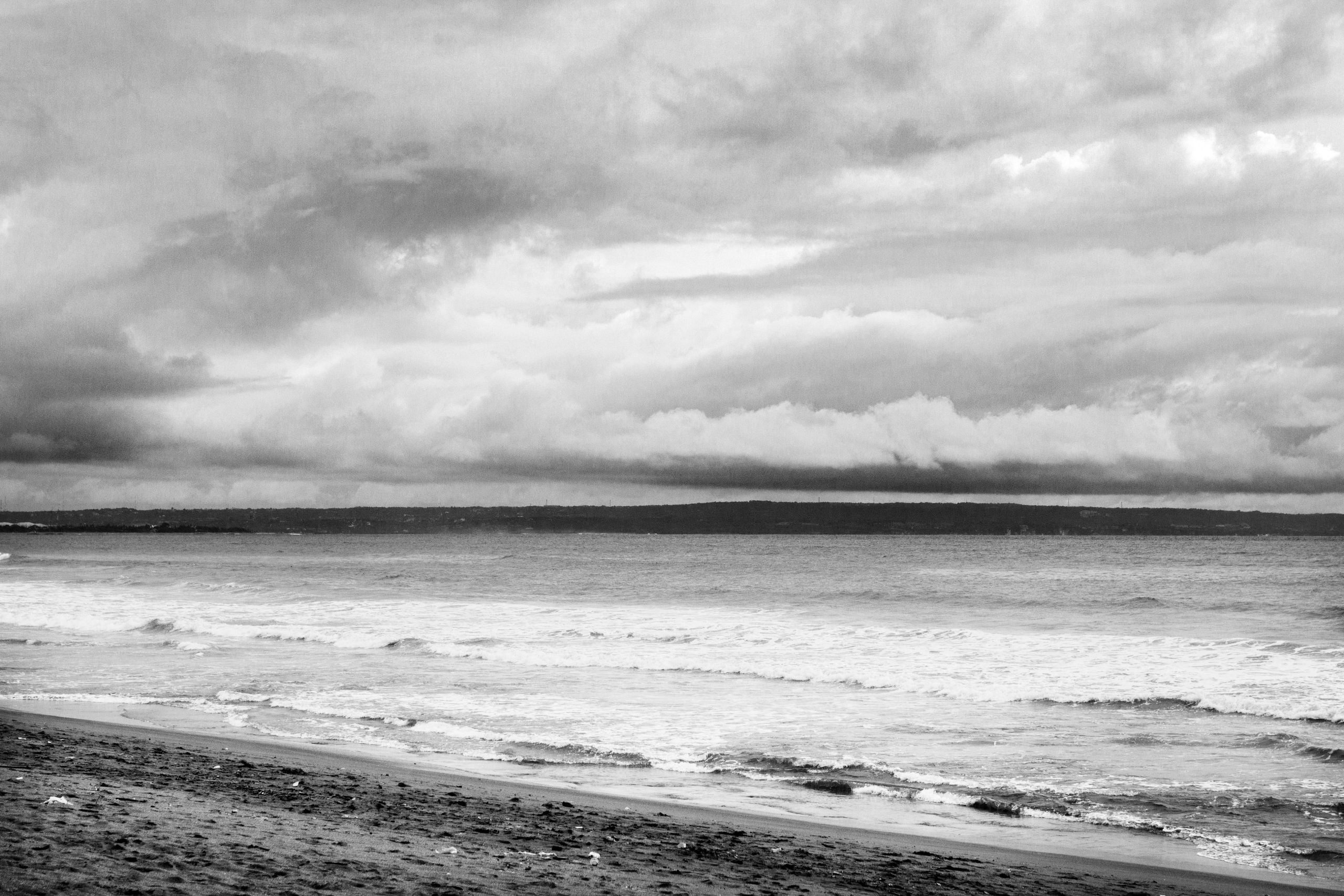grayscale photo of beach and sea